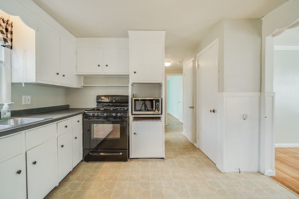 48 Fair Oak Road Springfield, MA 01128 - Photo 7 of 42 a kitchen with stainless steel appliances granite countertop a refrigerator and white cabinets