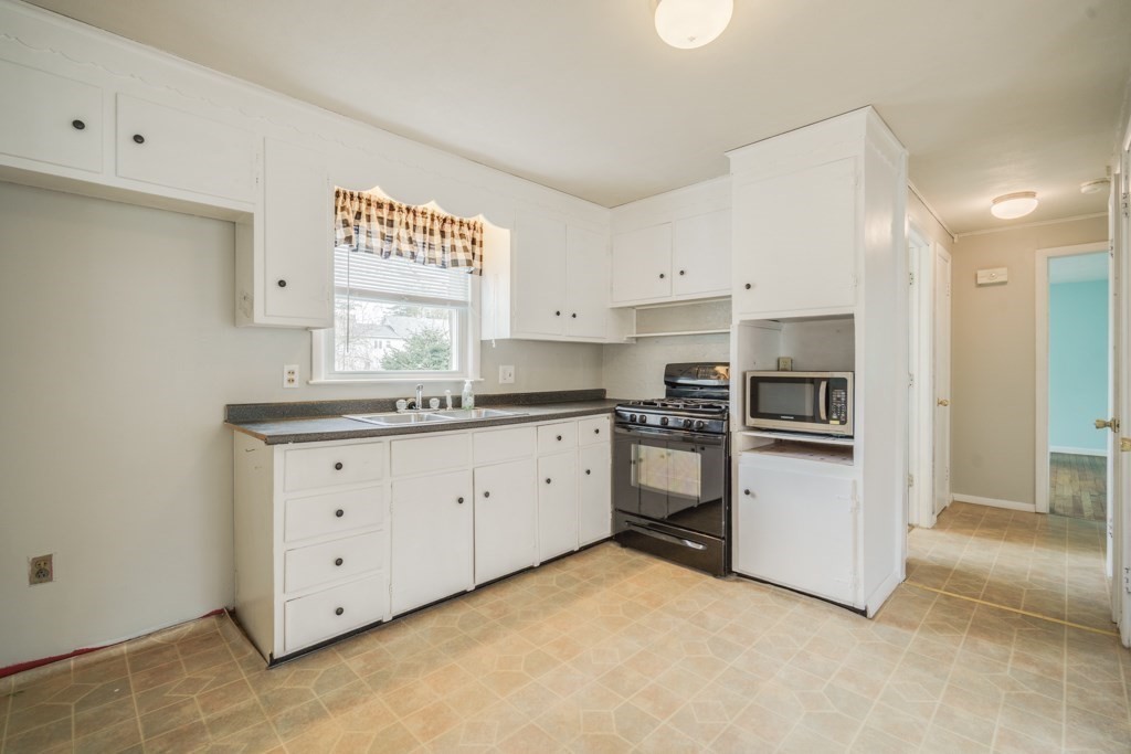 48 Fair Oak Road Springfield, MA 01128 - Photo 9 of 42 a kitchen with granite countertop white cabinets and stainless steel appliances