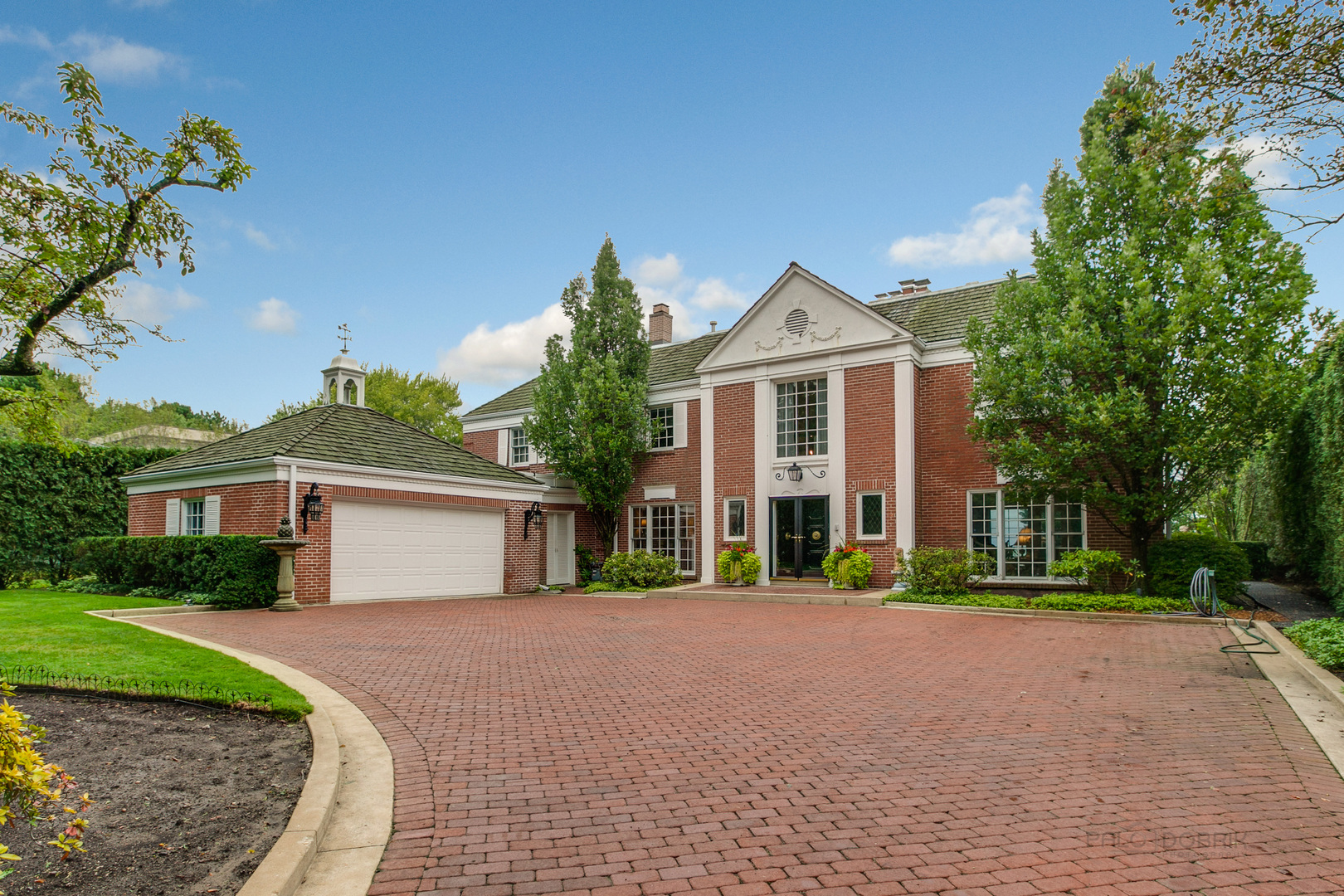 473 Sheridan Road Winnetka, IL 60093 - Photo 1 of 32 a front view of a house with a yard and potted plants