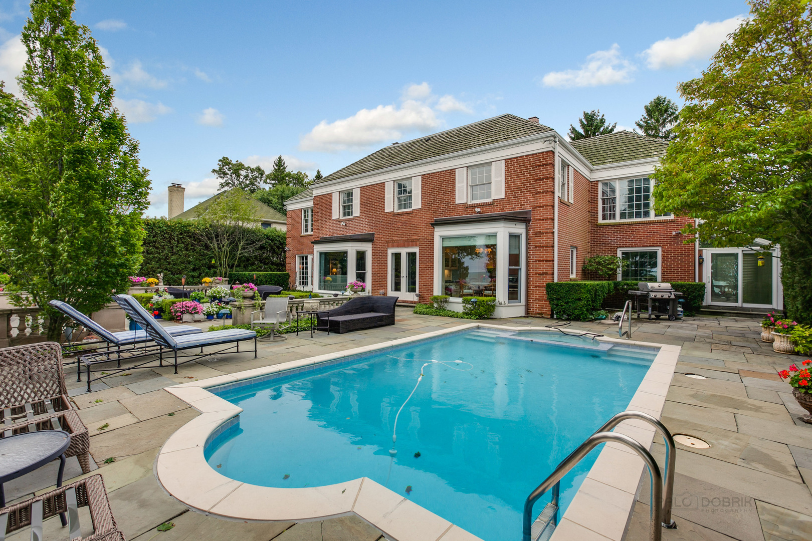 473 Sheridan Road Winnetka, IL 60093 - Photo 27 of 32 a view of a house with swimming pool and sitting area