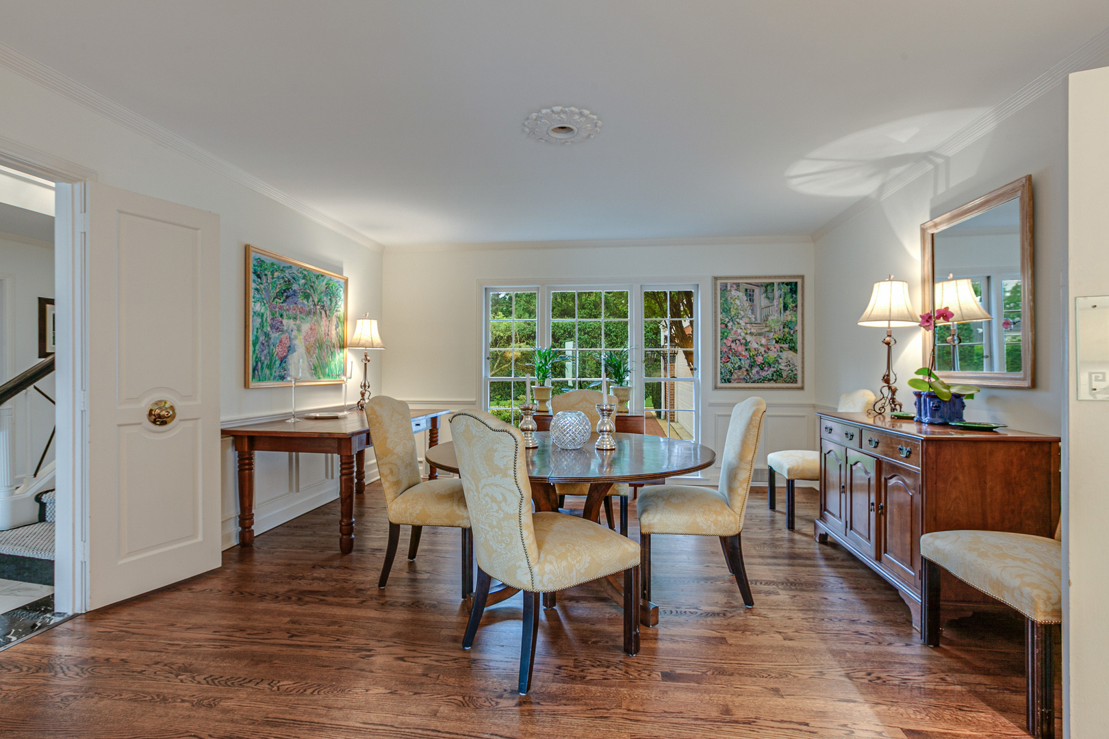 473 Sheridan Road Winnetka, IL 60093 - Photo 7 of 32 a dining room with wooden floor a chandelier a glass table and chairs
