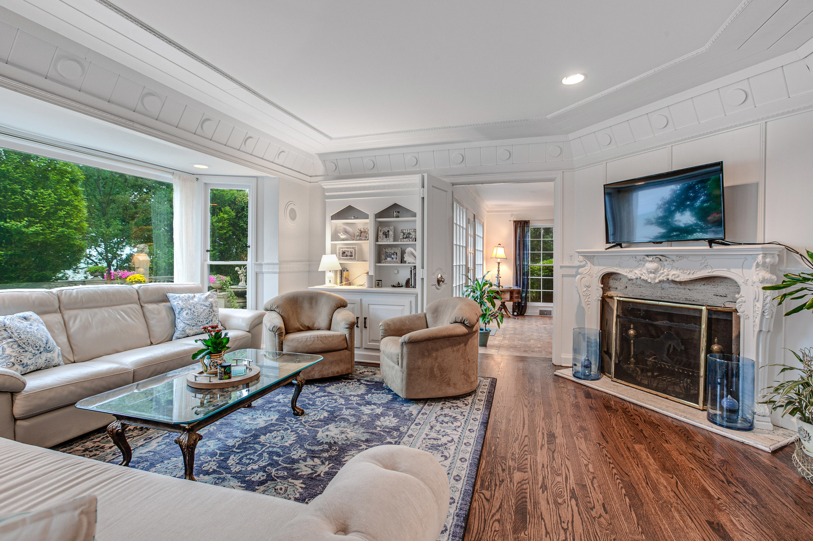 473 Sheridan Road Winnetka, IL 60093 - Photo 8 of 32 a living room with furniture a flat screen tv and a fireplace