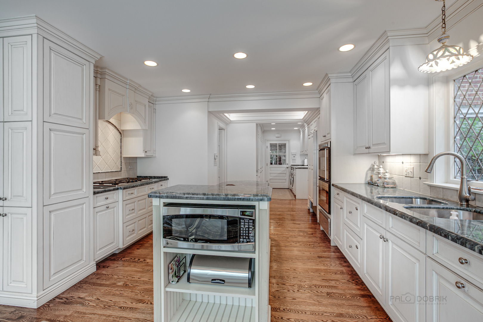 473 Sheridan Road Winnetka, IL 60093 - Photo 10 of 32 a large kitchen with stainless steel appliances granite countertop a stove a sink dishwasher and a refrigerator with wooden floor