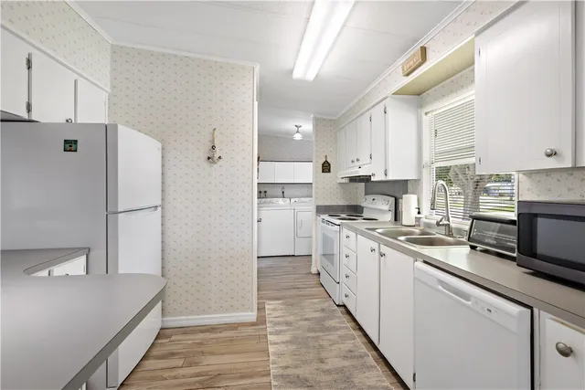 a kitchen with stainless steel appliances a refrigerator sink and cabinets