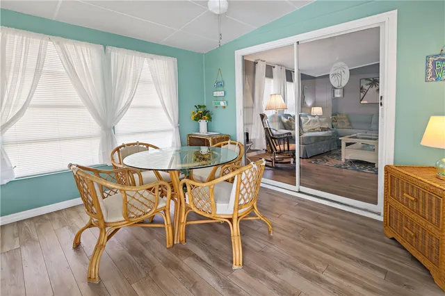 a dining room with furniture and wooden floor