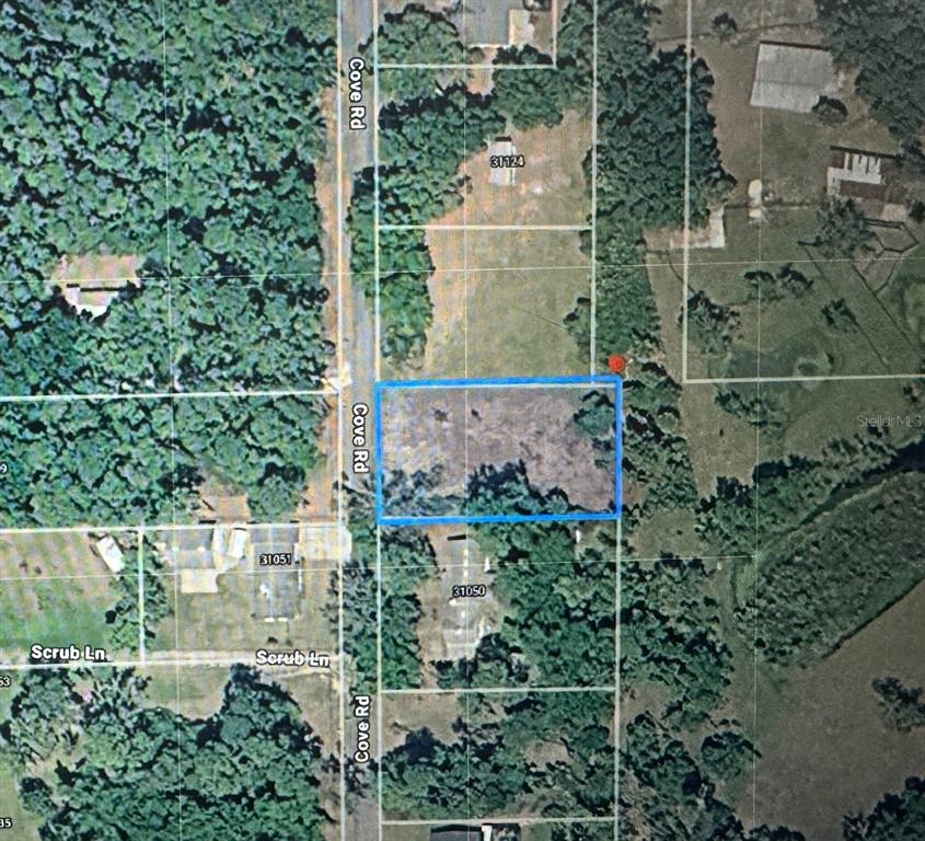 Cove Road Tavares, FL 32778 - Photo 2 of 16 an aerial view of a residential houses with yard