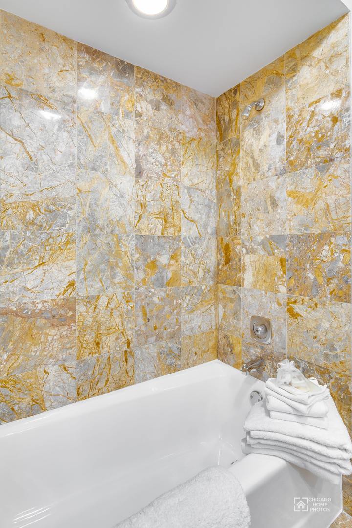 131 Chestnut Road Northbrook, IL 60062 - Photo 11 of 26 a bathroom with a bathtub and shower