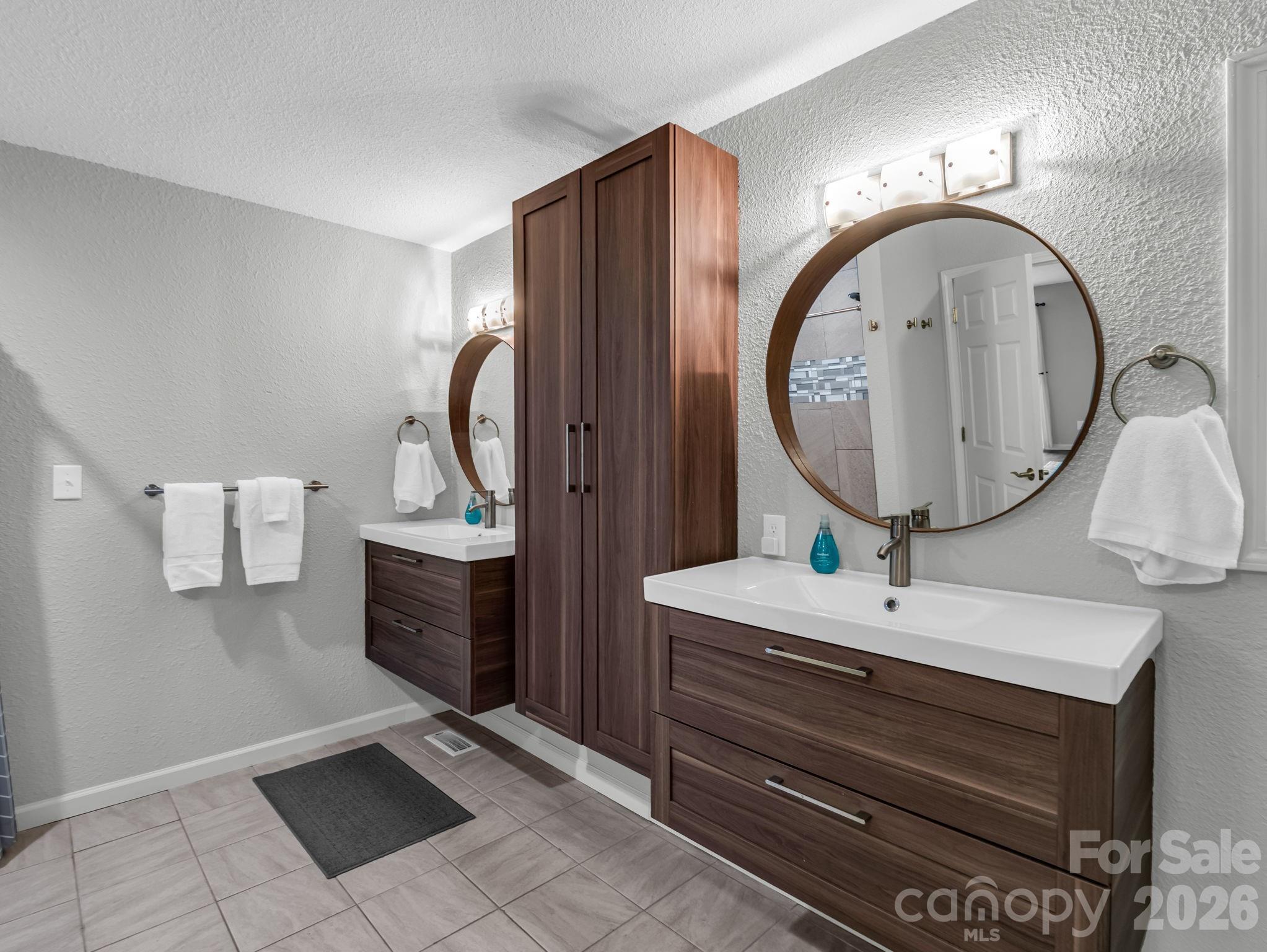 656 Cashiers Valley Road Brevard, NC 28712 - Photo 15 of 37 a room with round mirror and sink