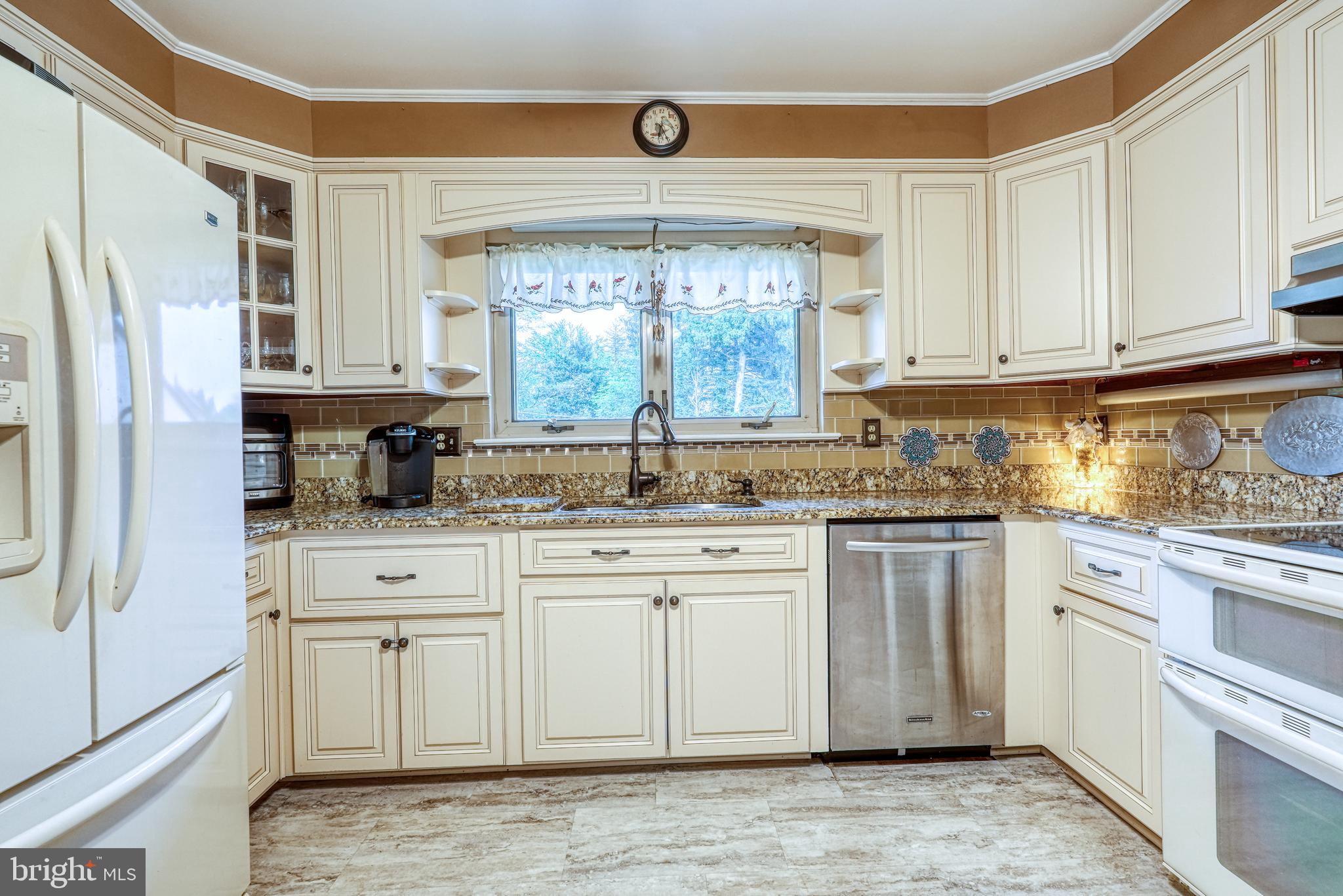 135 Holly Road Southampton, PA 18966 - Photo 17 of 52 a kitchen with stainless steel appliances granite countertop a stove a sink and a refrigerator
