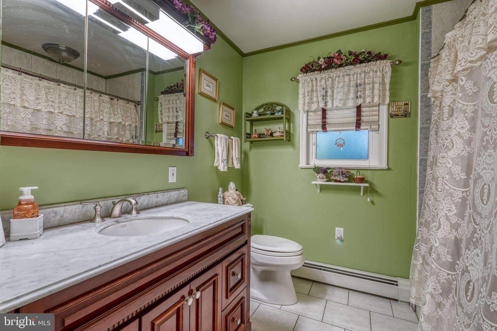 135 Holly Road Southampton, PA 18966 - Photo 20 of 52 a bathroom with a granite countertop toilet sink and mirror
