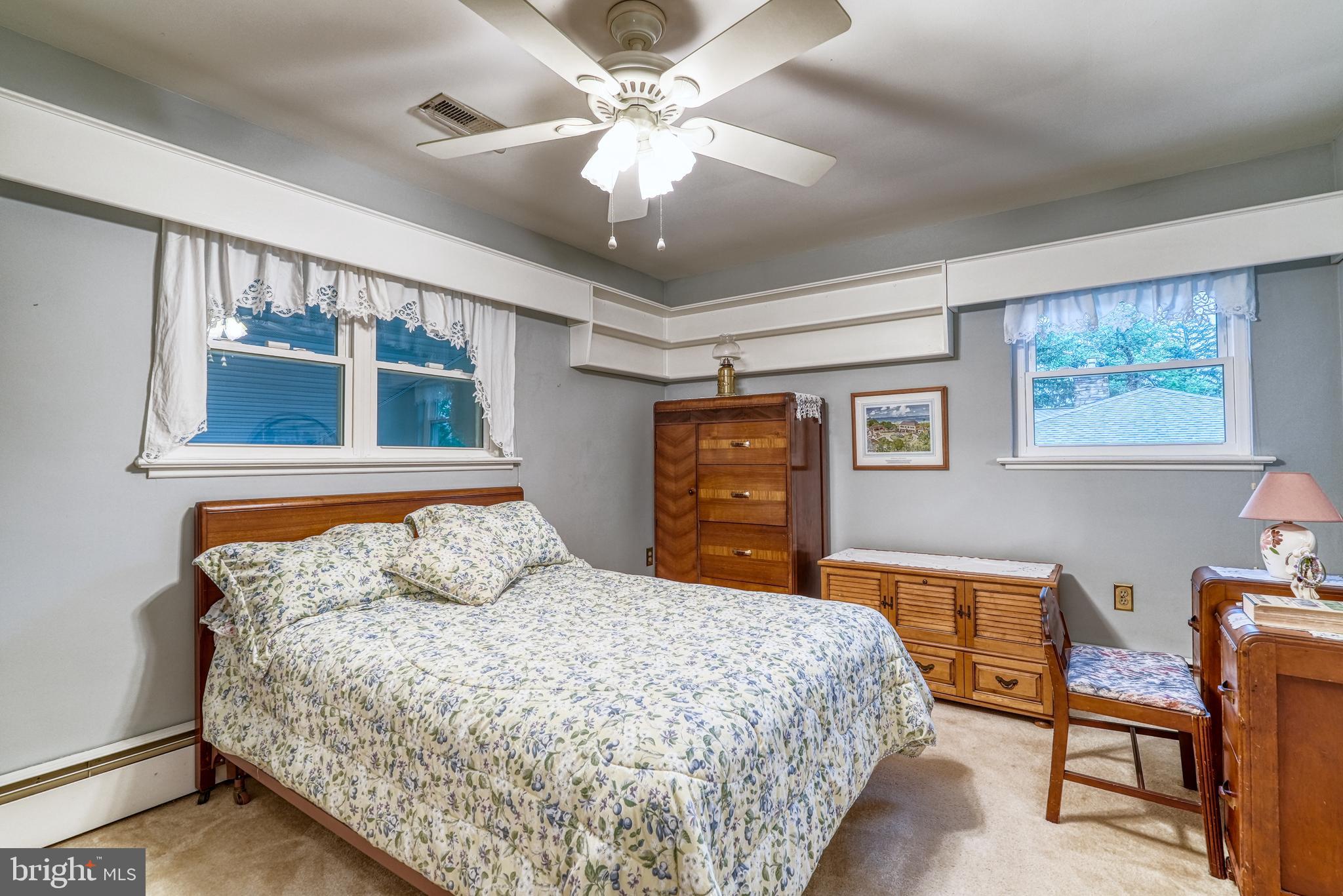 135 Holly Road Southampton, PA 18966 - Photo 26 of 52 a bedroom with a large bed and a chandelier