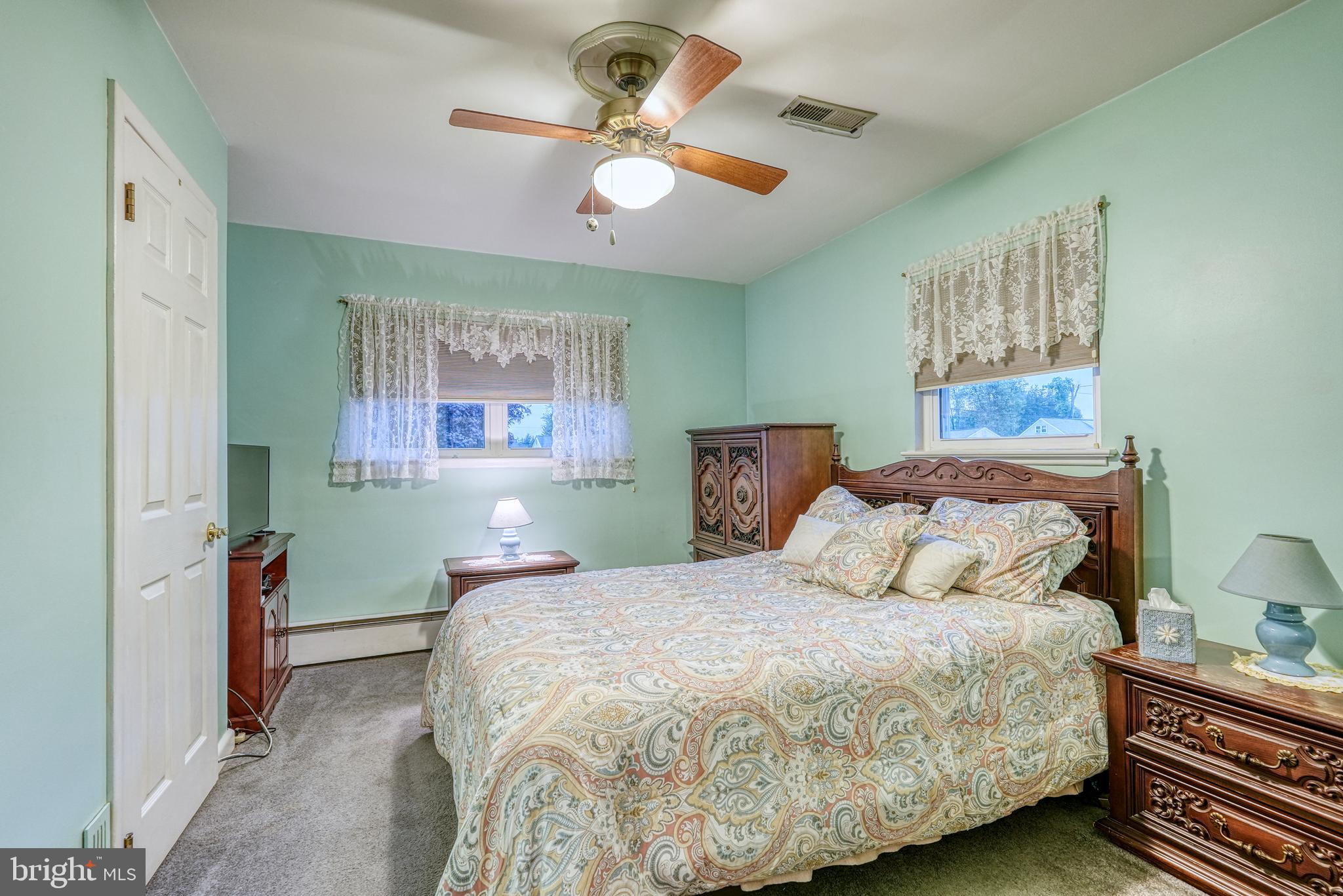 135 Holly Road Southampton, PA 18966 - Photo 33 of 52 a bedroom with a bed and a chandelier