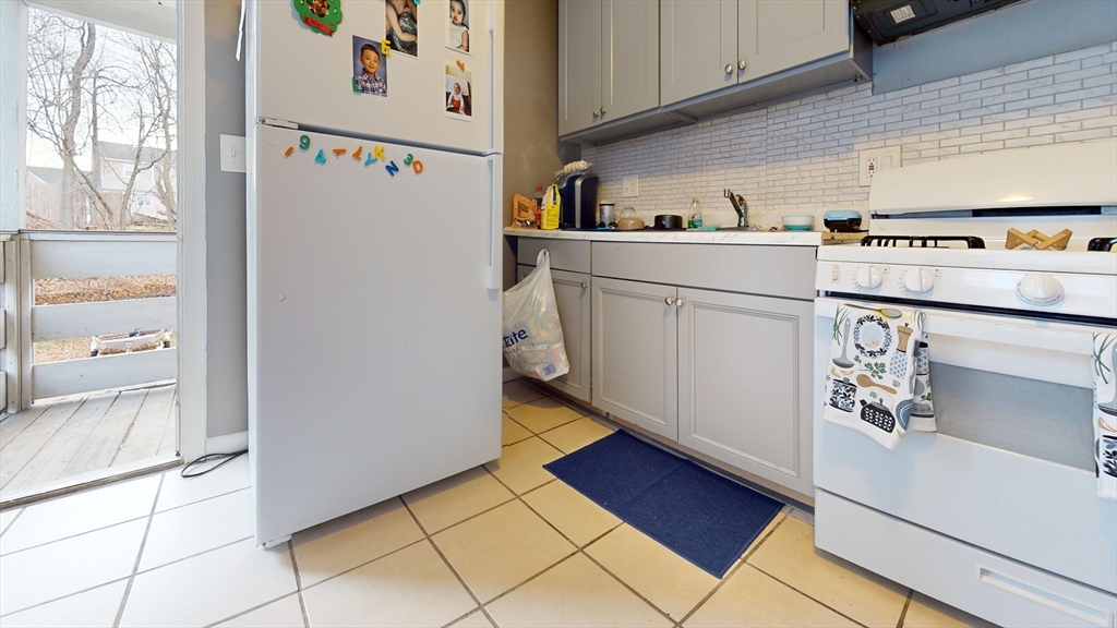 297 Main Street Springfield, MA 01151 - Photo 12 of 26 a kitchen with a refrigerator and a stove