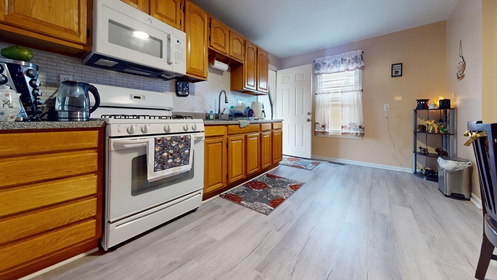 297 Main Street Springfield, MA 01151 - Photo 13 of 26 a kitchen with stainless steel appliances granite countertop a stove and a refrigerator
