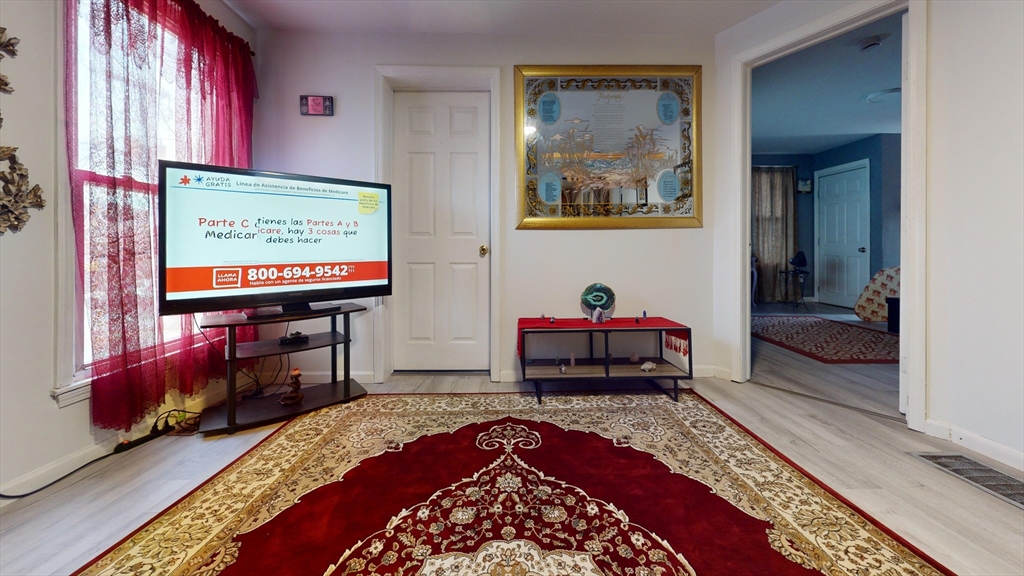 297 Main Street Springfield, MA 01151 - Photo 3 of 26 a bed room with a bed and a television