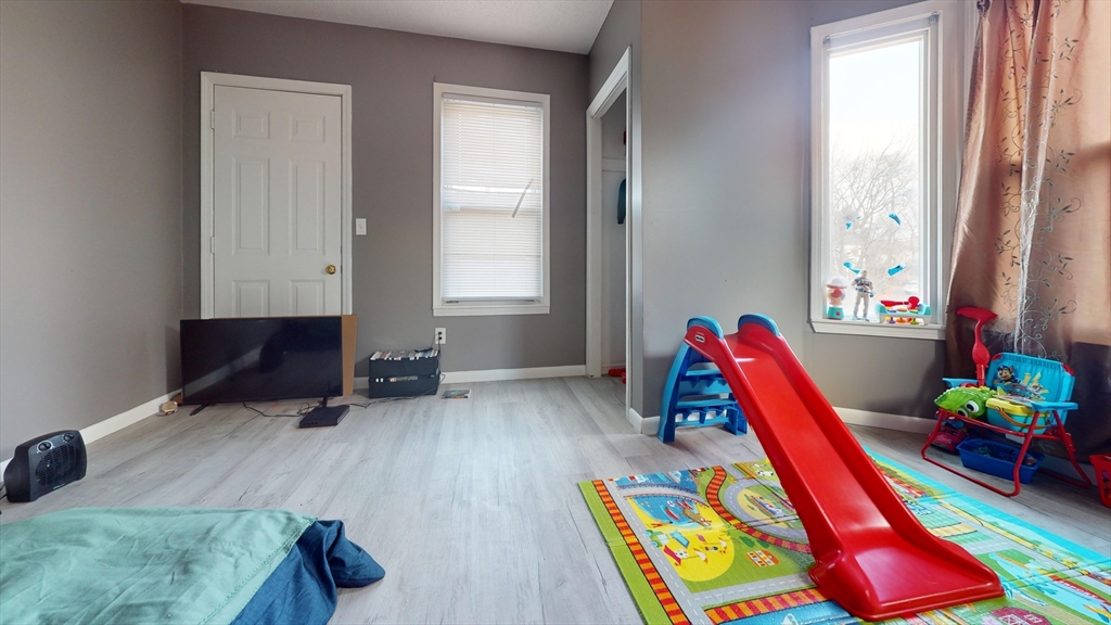 297 Main Street Springfield, MA 01151 - Photo 9 of 26 a room with furniture and a wooden floor