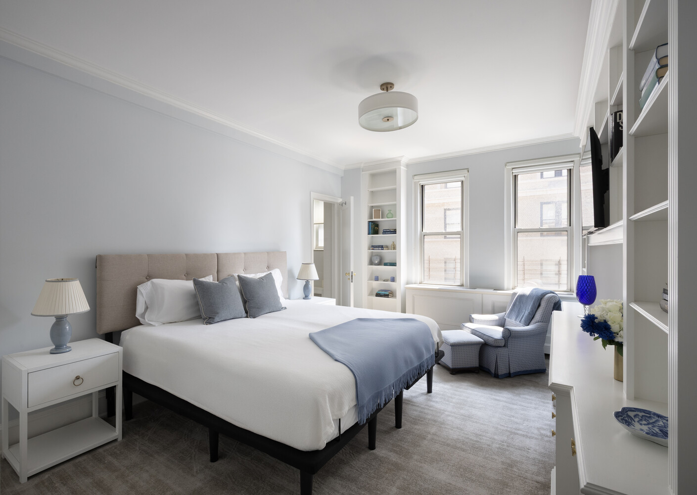 1165 Park Avenue, Unit 10B Manhattan, NY 10128 - Photo 10 of 15 a bedroom with a bed couch and a window