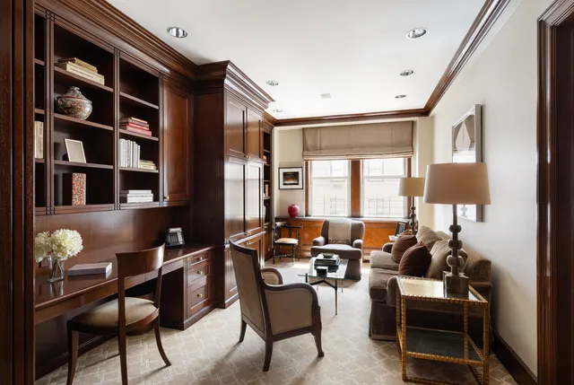 a bedroom with a bed couch and a window