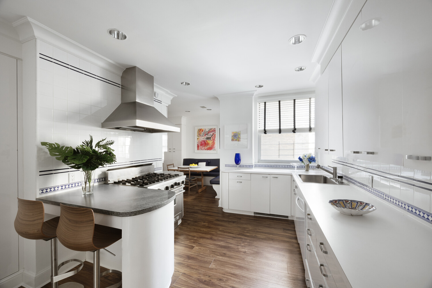 1165 Park Avenue, Unit 10B Manhattan, NY 10128 - Photo 4 of 15 a kitchen with a sink a stove and chairs