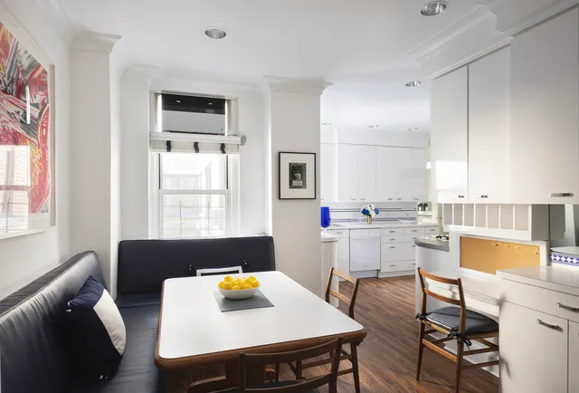 a kitchen with a sink a stove and chairs