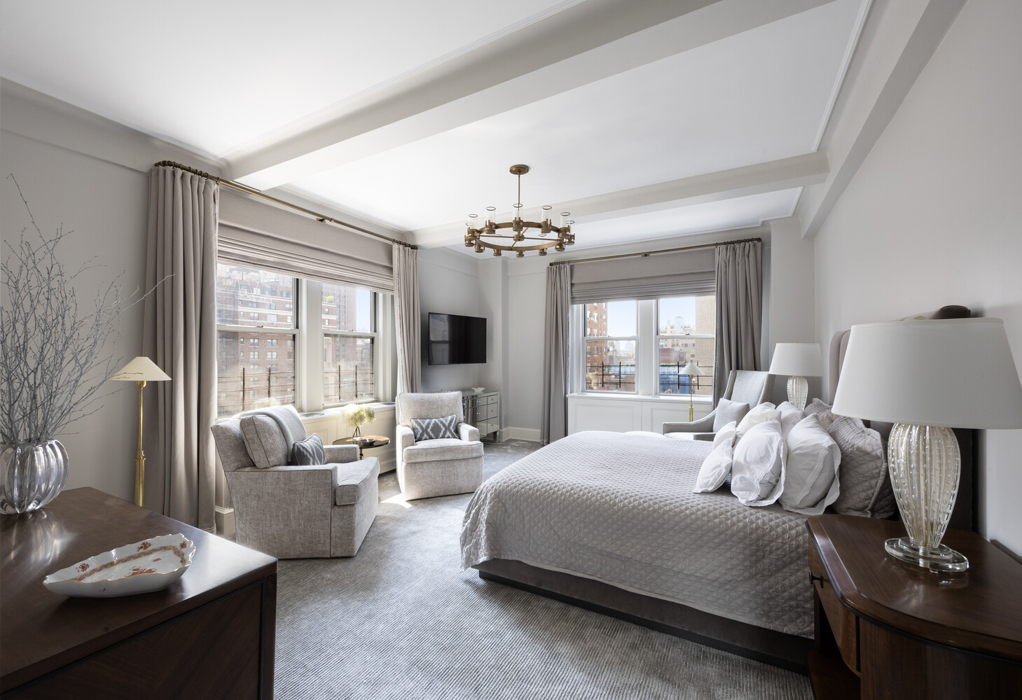 1165 Park Avenue, Unit 10B Manhattan, NY 10128 - Photo 6 of 15 a bedroom with a large bed and a chandelier