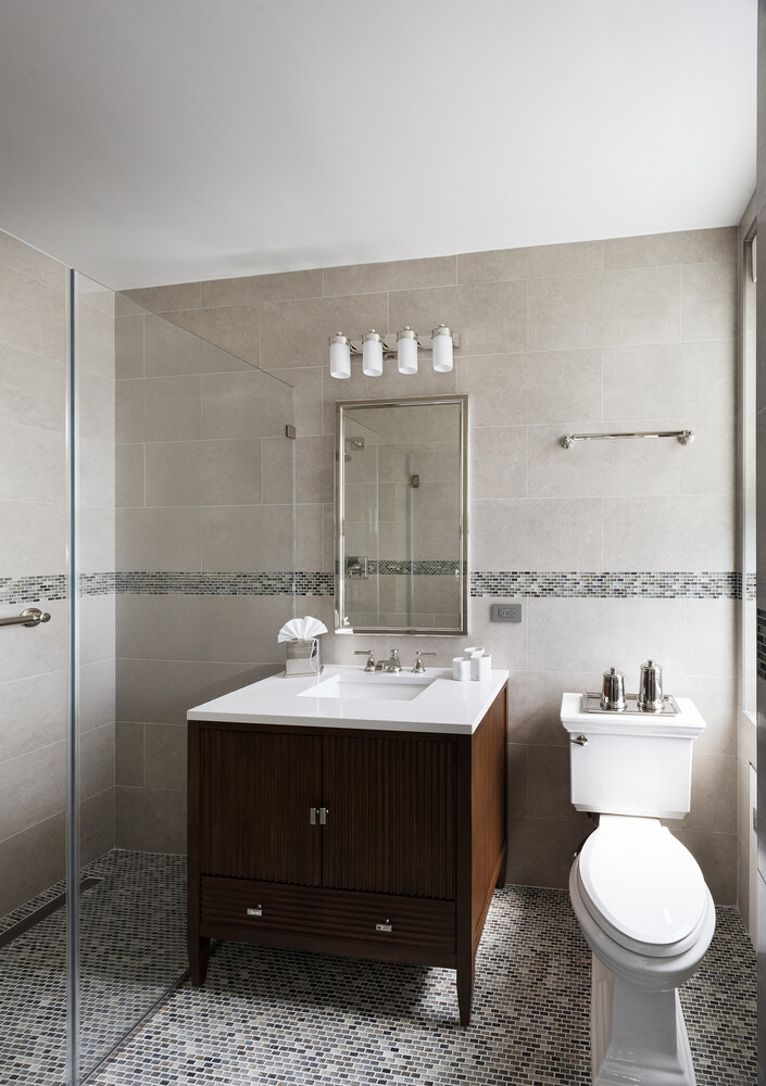 1165 Park Avenue, Unit 10B Manhattan, NY 10128 - Photo 7 of 15 a bathroom with a toilet sink and mirror