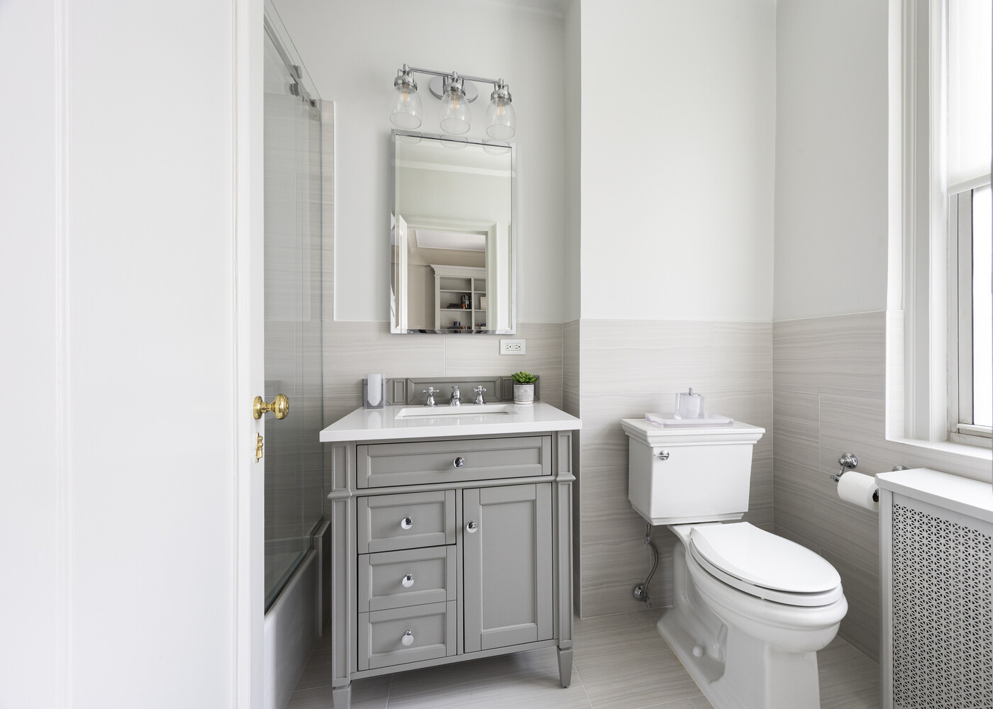1165 Park Avenue, Unit 10B Manhattan, NY 10128 - Photo 9 of 15 a bathroom with a toilet a sink and a mirror