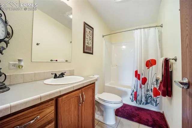 a bedroom with a bed a chair and a chandelier