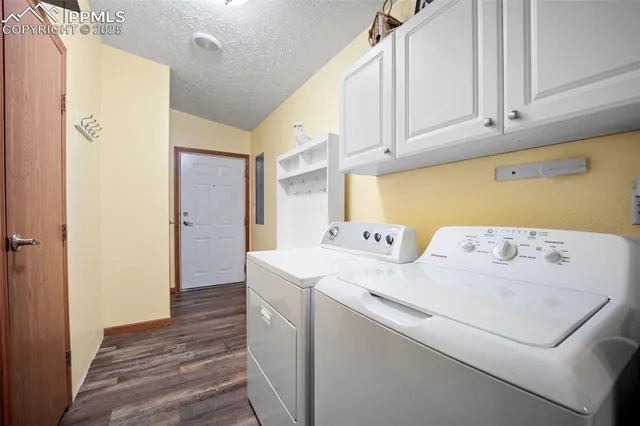 a utility room with cabinets washer and dryer