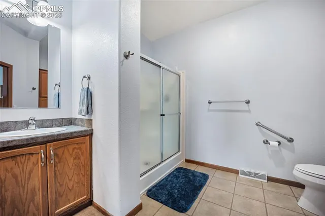 a spacious bathroom with a tub sink and mirror