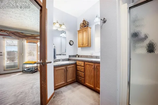 a kitchen with granite countertop a sink stove and refrigerator