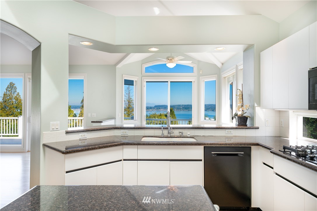 5332 Canvasback Loop Blaine, WA 98230 - Photo 11 of 40 a kitchen with granite countertop stainless steel appliances a sink and cabinets