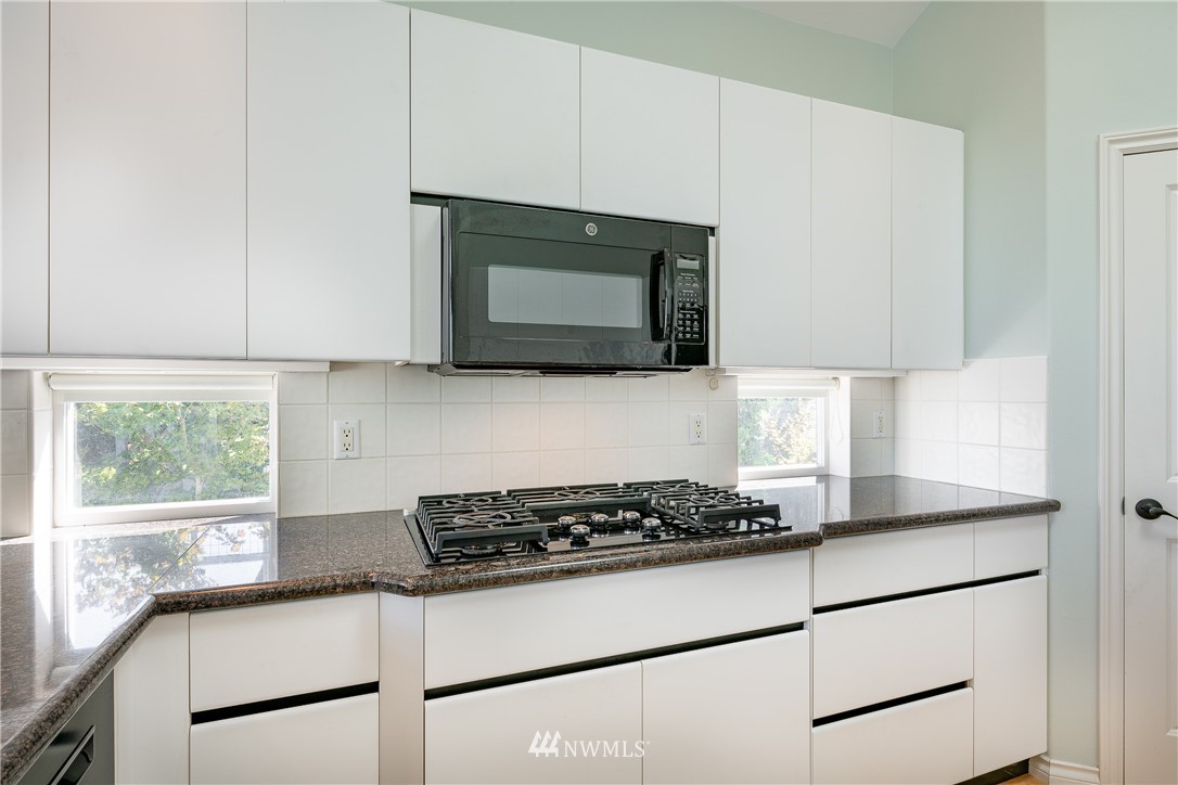 5332 Canvasback Loop Blaine, WA 98230 - Photo 12 of 40 a kitchen with stainless steel appliances granite countertop cabinets and a stove top oven