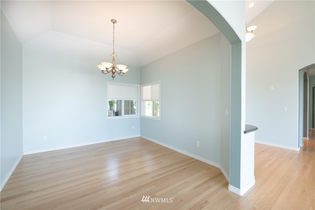 5332 Canvasback Loop Blaine, WA 98230 - Photo 14 of 40 a view of a room with wooden floor chandelier and windows