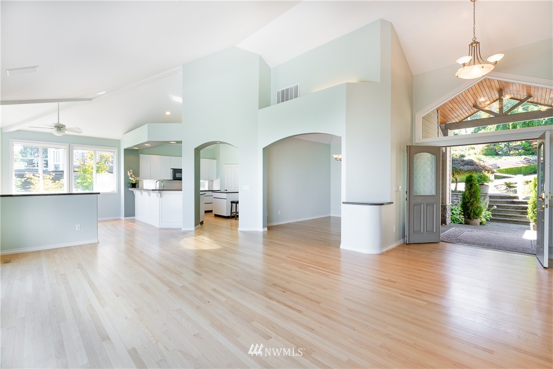 5332 Canvasback Loop Blaine, WA 98230 - Photo 15 of 40 a view of a living room kitchen with furniture and wooden floor