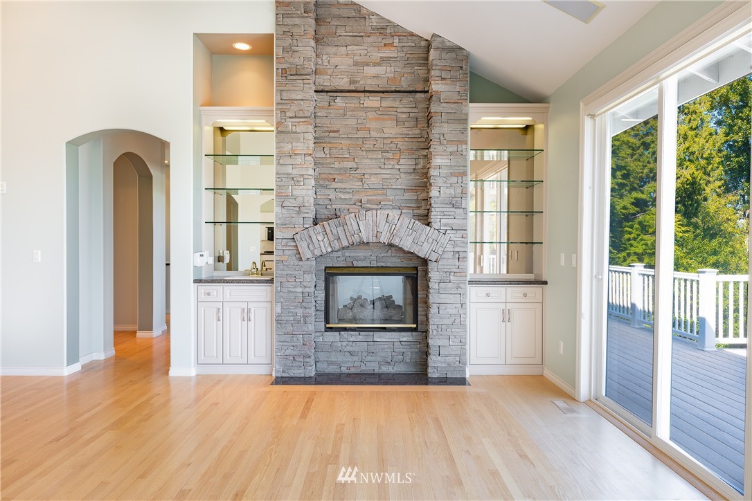 5332 Canvasback Loop Blaine, WA 98230 - Photo 16 of 40 a view of empty room with a fireplace and wooden floor