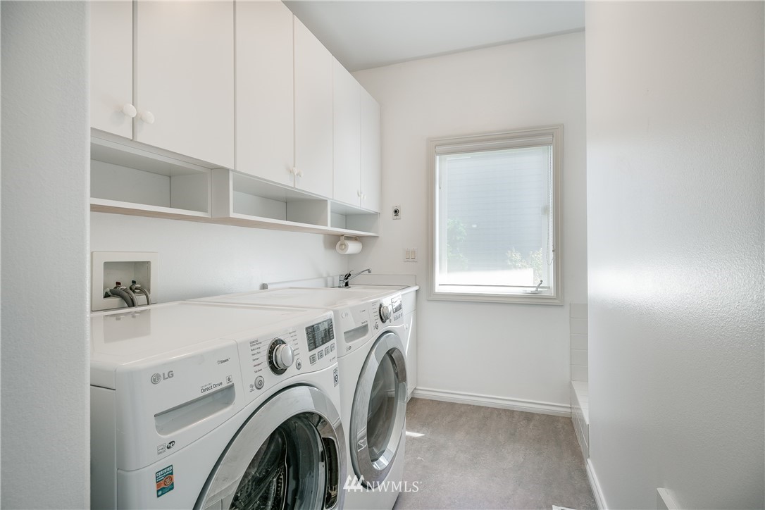 5332 Canvasback Loop Blaine, WA 98230 - Photo 20 of 40 a view of washer and dryer with kitchen in the background