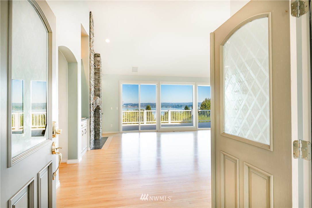 5332 Canvasback Loop Blaine, WA 98230 - Photo 3 of 40 a view of a living room with a floor to ceiling window and wooden floor