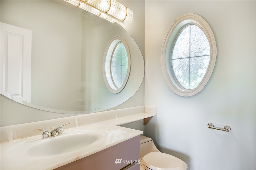 5332 Canvasback Loop Blaine, WA 98230 - Photo 22 of 40 a bathroom with a toilet a sink and a mirror