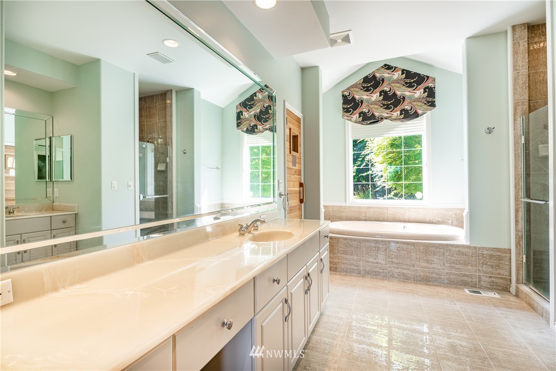 5332 Canvasback Loop Blaine, WA 98230 - Photo 26 of 40 a spacious bathroom with a tub sink and large mirror
