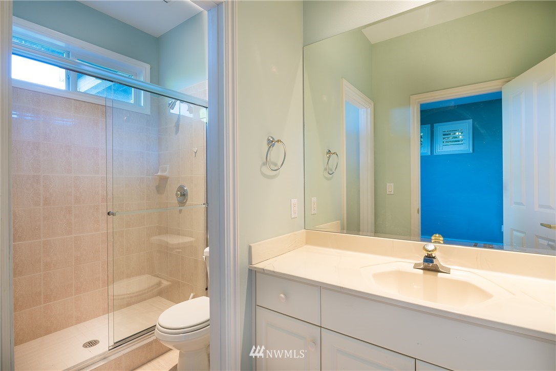 5332 Canvasback Loop Blaine, WA 98230 - Photo 30 of 40 a bathroom with a bathtub shower sink vanity and toilet