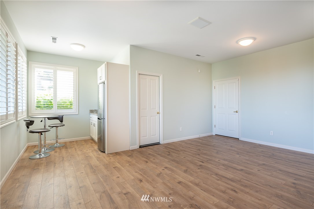 5332 Canvasback Loop Blaine, WA 98230 - Photo 33 of 40 a view of empty room with wooden floor and floor to ceiling window
