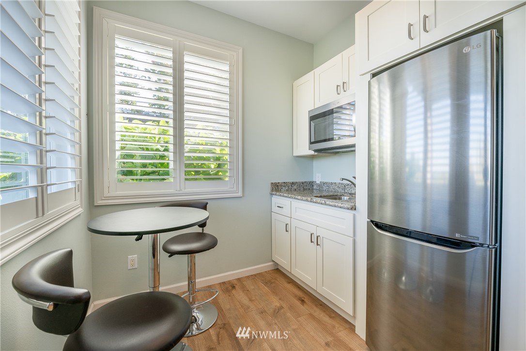 5332 Canvasback Loop Blaine, WA 98230 - Photo 35 of 40 a kitchen with stainless steel appliances granite countertop a refrigerator a sink a stove and a refrigerator with wooden floor