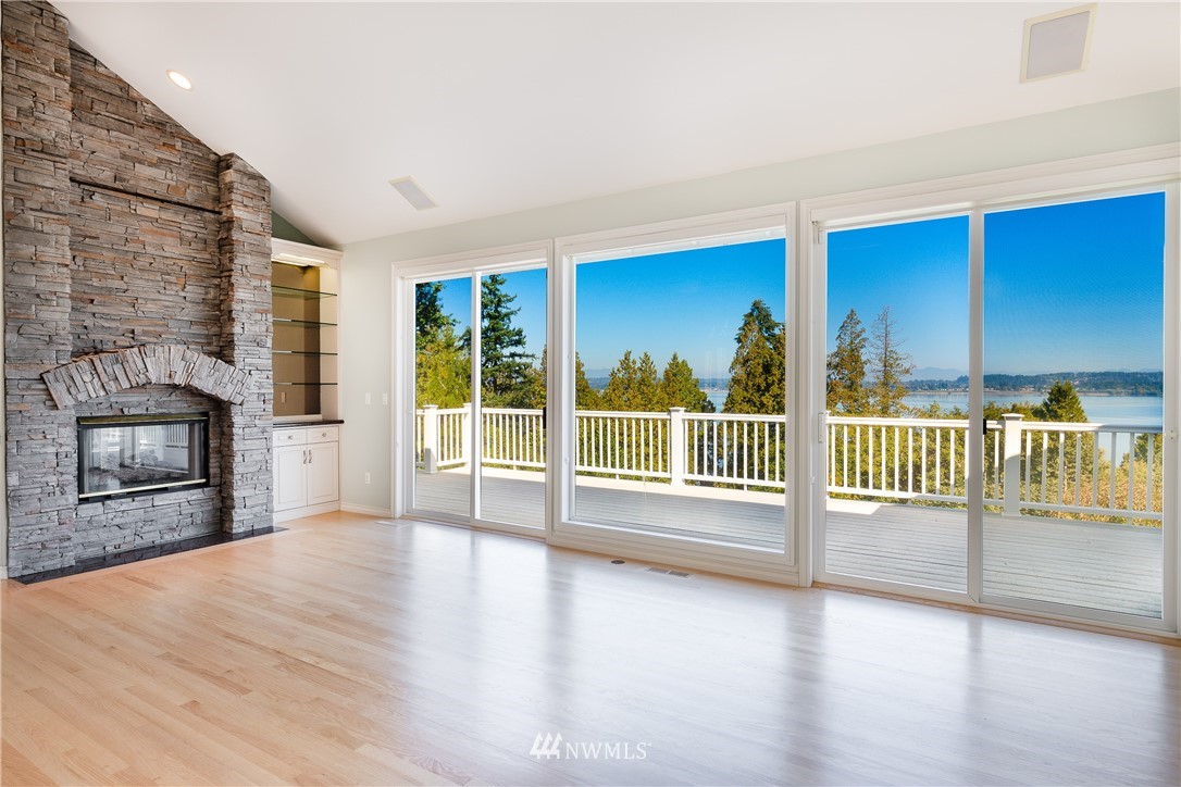5332 Canvasback Loop Blaine, WA 98230 - Photo 5 of 40 an empty room with wooden floor and fireplace