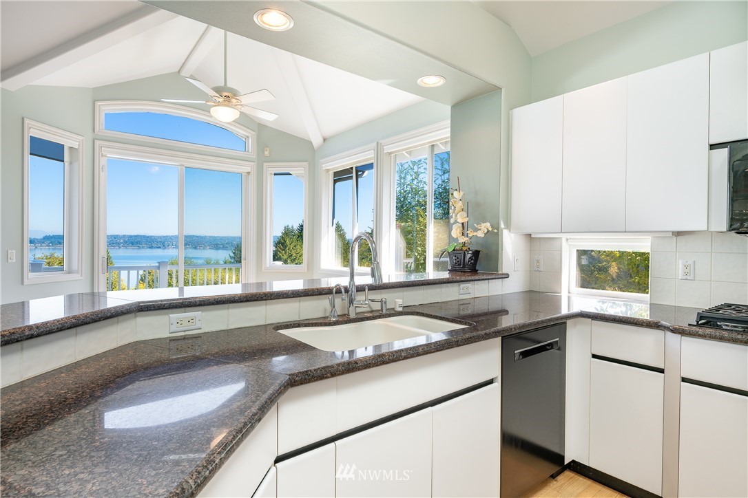5332 Canvasback Loop Blaine, WA 98230 - Photo 9 of 40 a kitchen with granite countertop a sink and white cabinets