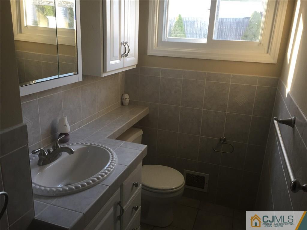 19 Fordham Road Old Bridge, NJ 08859 - Photo 8 of 16 a bathroom with a sink a toilet and a window