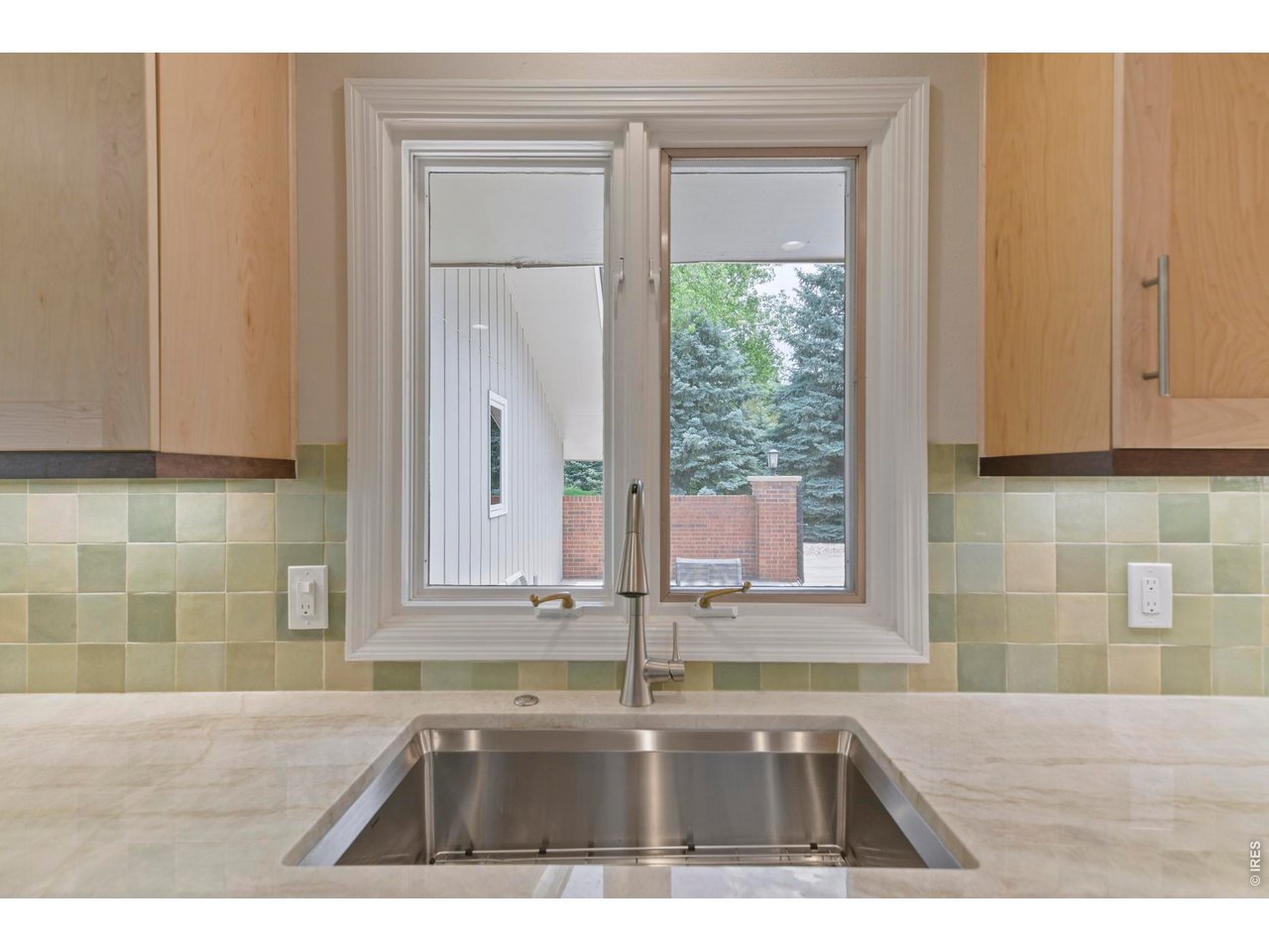 19 Ridge Road Boulder, CO 80303 - Photo 20 of 49 New Kitchen Sink and Faucet peers out to private front patio and beyond. Designer chosen tile back splash pulls it all together!