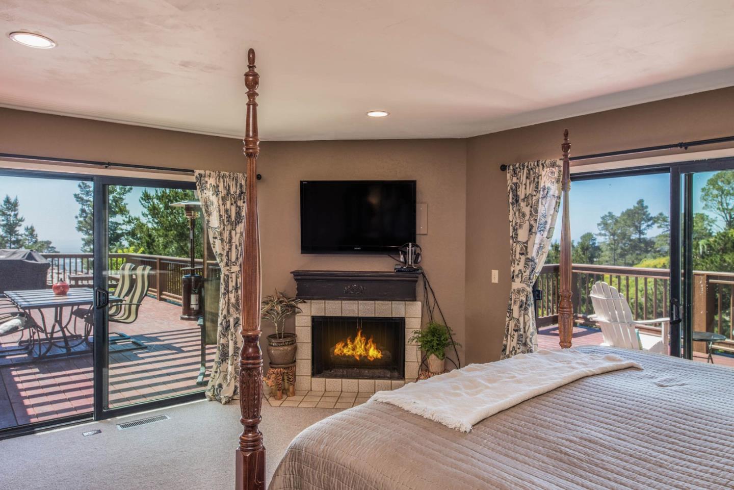 24800 Outlook Drive Carmel, CA 93923 - Photo 11 of 17 a bedroom with a bed and a flat screen tv