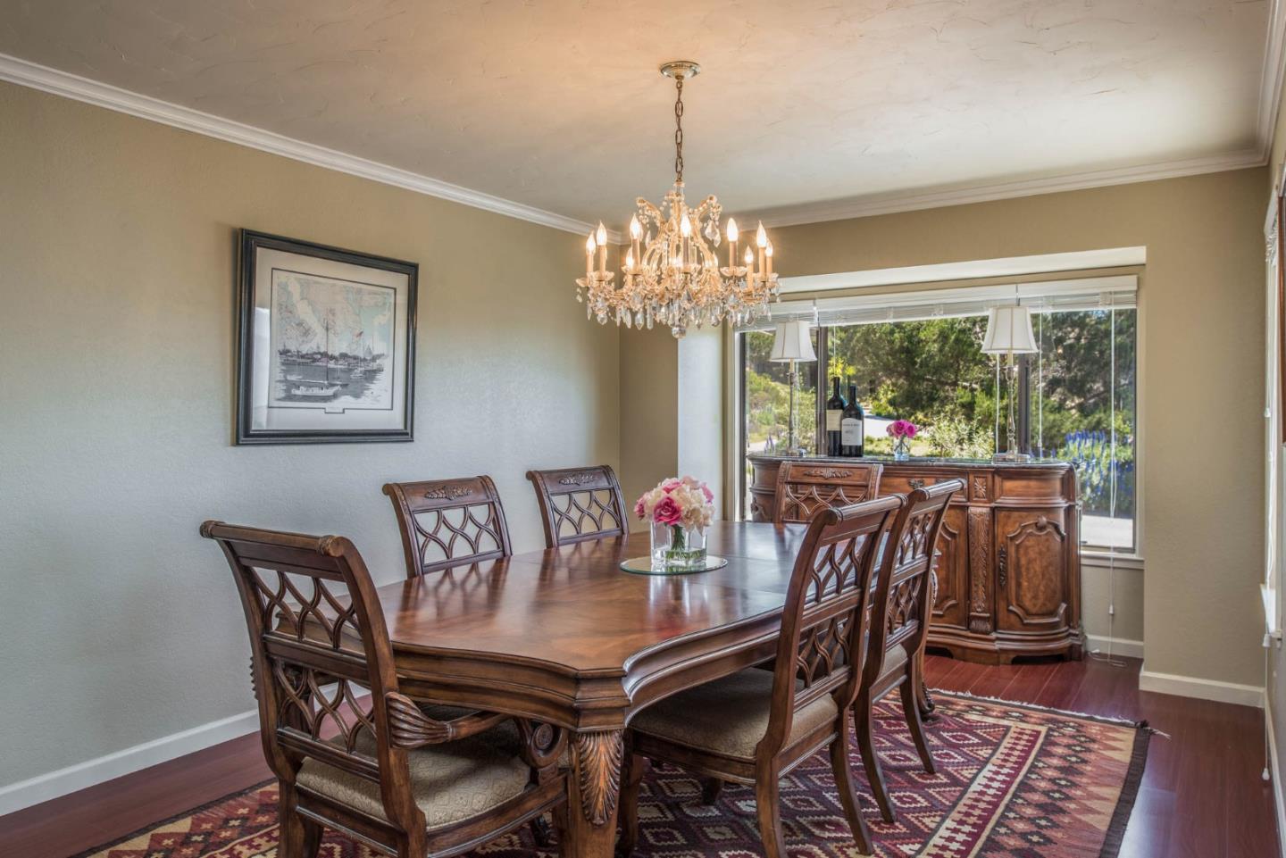 24800 Outlook Drive Carmel, CA 93923 - Photo 8 of 17 a view of a dining room with furniture a chandelier and wooden floor
