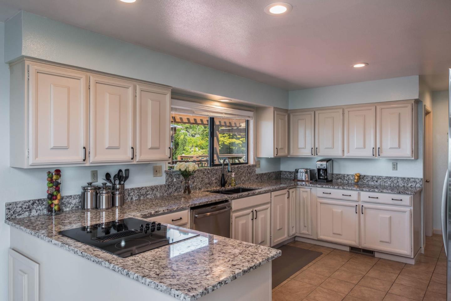 24800 Outlook Drive Carmel, CA 93923 - Photo 9 of 17 a kitchen with a sink stove top oven and cabinets